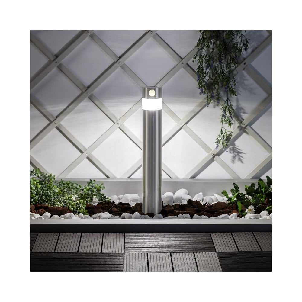 Outdoor solar pillar light illuminating a path.